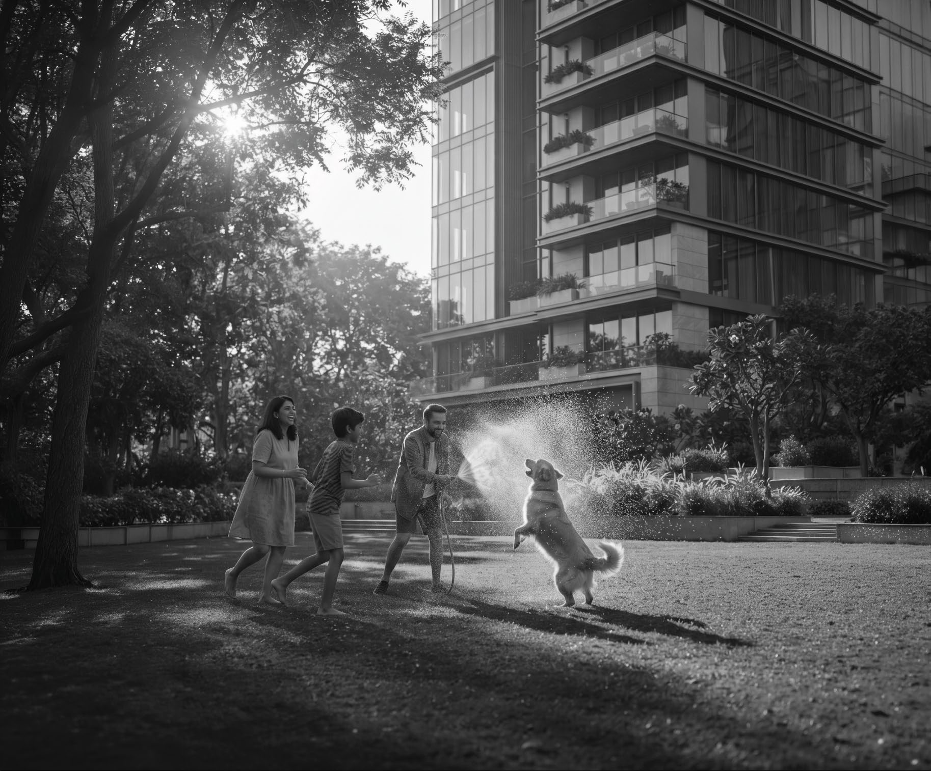 A family playing with their dog on the township's landscaped green